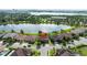 Beautiful aerial view of a lakefront home with lush landscaping and a tile roof at 8231 Chilton Dr, Orlando, FL 32836