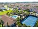 Aerial view of the community pool, clubhouse, and tennis courts surrounded by manicured landscaping at 8231 Chilton Dr, Orlando, FL 32836