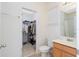 Bright bathroom features a walk-in closet, tile floors, a window and single sink vanity at 8231 Chilton Dr, Orlando, FL 32836