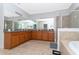 Bathroom with a spacious countertop, dual sinks, and mirrors at 8231 Chilton Dr, Orlando, FL 32836