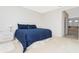 Bright bedroom featuring a comfortable bed, white nightstand, and access to the bathroom at 8231 Chilton Dr, Orlando, FL 32836