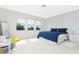Sunlit bedroom with three large windows and a comfortable blue-themed decor at 8231 Chilton Dr, Orlando, FL 32836