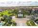 Grand entrance to a Primary-planned community with palm trees, a fountain, and manicured landscaping at 8231 Chilton Dr, Orlando, FL 32836