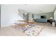 Open dining area with a wood table, stainless steel bench, and a colorful rug, adjacent to the modern kitchen and living room at 8231 Chilton Dr, Orlando, FL 32836
