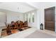 Elegant dining room with a dark wood table, arched windows and decorative lighting at 8231 Chilton Dr, Orlando, FL 32836