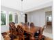 Stylish dining room features a dark wood table with seating for eight and lots of light at 8231 Chilton Dr, Orlando, FL 32836
