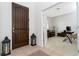 Inviting home foyer featuring a dark wood front door and a glimpse of a bright office at 8231 Chilton Dr, Orlando, FL 32836