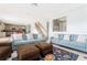 Spacious living room with sofas, ottomans, view of kitchen and stair case at 8231 Chilton Dr, Orlando, FL 32836