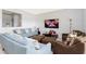 Inviting living room featuring comfortable sofas, stylish decor, and a large TV for entertainment at 8231 Chilton Dr, Orlando, FL 32836