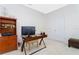 A bright home office featuring a bookcase, desk, and dual-door closet at 8231 Chilton Dr, Orlando, FL 32836