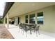 Covered patio includes a table and seating, perfect for outdoor entertaining in the beautiful backyard at 8231 Chilton Dr, Orlando, FL 32836
