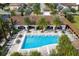 Stunning aerial view of the community pool with palm trees and lounge area at 8231 Chilton Dr, Orlando, FL 32836