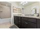 Bathroom features a double vanity with granite countertop and a separate tub and shower at 9026 Rhodes St, Kissimmee, FL 34747