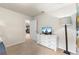 Comfortable bedroom with dresser, TV and an open doorway to another room at 9026 Rhodes St, Kissimmee, FL 34747