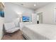 Simple bedroom with a comfortable bed, accent chair, and a clean, modern design at 9026 Rhodes St, Kissimmee, FL 34747