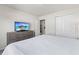 Bedroom with a queen-size bed, light gray dresser, and a flat-screen television at 9026 Rhodes St, Kissimmee, FL 34747