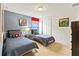Cozy bedroom features two twin beds with superhero-themed decor and a window at 9026 Rhodes St, Kissimmee, FL 34747