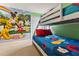 Charming bedroom with a bunk bed, colorful Mickey Mouse mural, and a view of the exterior at 9026 Rhodes St, Kissimmee, FL 34747