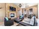 Lounge area featuring comfortable wicker seating, fireplace, and ceiling fan at 9026 Rhodes St, Kissimmee, FL 34747