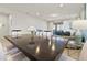 Open-concept dining area with a large table, contemporary seating, and seamless flow to the living space at 9026 Rhodes St, Kissimmee, FL 34747