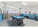 Finished garage transformed into a game room with a pool table, air hockey, and curtains at 9026 Rhodes St, Kissimmee, FL 34747
