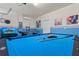 Spacious game room featuring a pool table, tv, and eclectic decor for hours of fun and entertainment at 9026 Rhodes St, Kissimmee, FL 34747