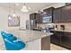 Stylish kitchen featuring granite counters, stainless steel appliances, and sleek dark wood cabinets at 9026 Rhodes St, Kissimmee, FL 34747