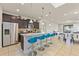 Kitchen featuring stainless steel appliances, dark wood cabinets, and a spacious granite countertop island at 9026 Rhodes St, Kissimmee, FL 34747