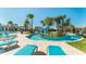 Community lazy river with palm trees and comfortable lounge chairs at 9026 Rhodes St, Kissimmee, FL 34747