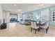 Bright, open living room with modern décor, tile flooring, and access to outdoor patio at 9026 Rhodes St, Kissimmee, FL 34747