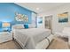 Relaxing bedroom with a comfortable king bed, stylish decor, and calming blue accent wall at 9026 Rhodes St, Kissimmee, FL 34747