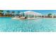 Expansive pool area with ample seating under a shaded pergola, creating a perfect spot for lounging and socializing at 9026 Rhodes St, Kissimmee, FL 34747