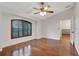 Bright bedroom featuring hardwood floors, plantation shutters, and a ceiling fan at 10924 Dearden Cir, Orlando, FL 32817