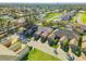 An elevated aerial view captures townhomes with green lawns, landscaping, and brick driveways at 114 Tuscany Villas Dr, Edgewater, FL 32141