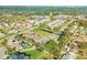 An aerial view features a pond, manicured green space, and multiple residential townhomes at 114 Tuscany Villas Dr, Edgewater, FL 32141