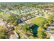 An aerial view of the community features lush landscaping, ponds, and residential townhomes at 114 Tuscany Villas Dr, Edgewater, FL 32141