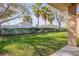 A relaxing backyard view features a privacy fence, manicured hedges, and lush green grass at 114 Tuscany Villas Dr, Edgewater, FL 32141