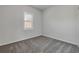 This bedroom features a neutral carpet with a bright window at 114 Tuscany Villas Dr, Edgewater, FL 32141
