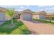 Charming single-story home with a brick driveway and well-manicured lawn at 114 Tuscany Villas Dr, Edgewater, FL 32141