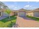 Charming single-story villa with a brick driveway and well-maintained landscaping at 114 Tuscany Villas Dr, Edgewater, FL 32141