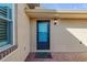 Close-up of the front door with a storm door and brick walkway at 114 Tuscany Villas Dr, Edgewater, FL 32141