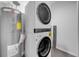 Efficient laundry area with stacked washer and dryer next to the hot water tank at 114 Tuscany Villas Dr, Edgewater, FL 32141