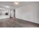 Open-concept living room features sleek hardwood flooring and neutral walls for easy customization at 114 Tuscany Villas Dr, Edgewater, FL 32141
