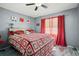 Comfortable bedroom features a comfortable bed, red accents and window, and grey walls at 1170 Calle Del Rey # D, Casselberry, FL 32707