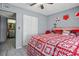Bedroom featuring a bed, view to a walk-in closet and bathroom, and white closet doors at 1170 Calle Del Rey # D, Casselberry, FL 32707