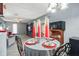 Dining area with modern table set, hardwood-style floors, and adjacent living space at 1170 Calle Del Rey # D, Casselberry, FL 32707
