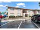 Condominium exterior featuring stucco, trimmed windows, and a lush landscape at 1170 Calle Del Rey # D, Casselberry, FL 32707