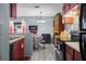 Cozy kitchen with red cabinets, black appliances, eat-in kitchen table at 1170 Calle Del Rey # D, Casselberry, FL 32707