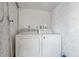 Bright laundry room with full size white washer and dryer at 1170 Calle Del Rey # D, Casselberry, FL 32707