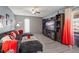 The living room features wood style flooring, a large television, and a black sofa at 1170 Calle Del Rey # D, Casselberry, FL 32707
